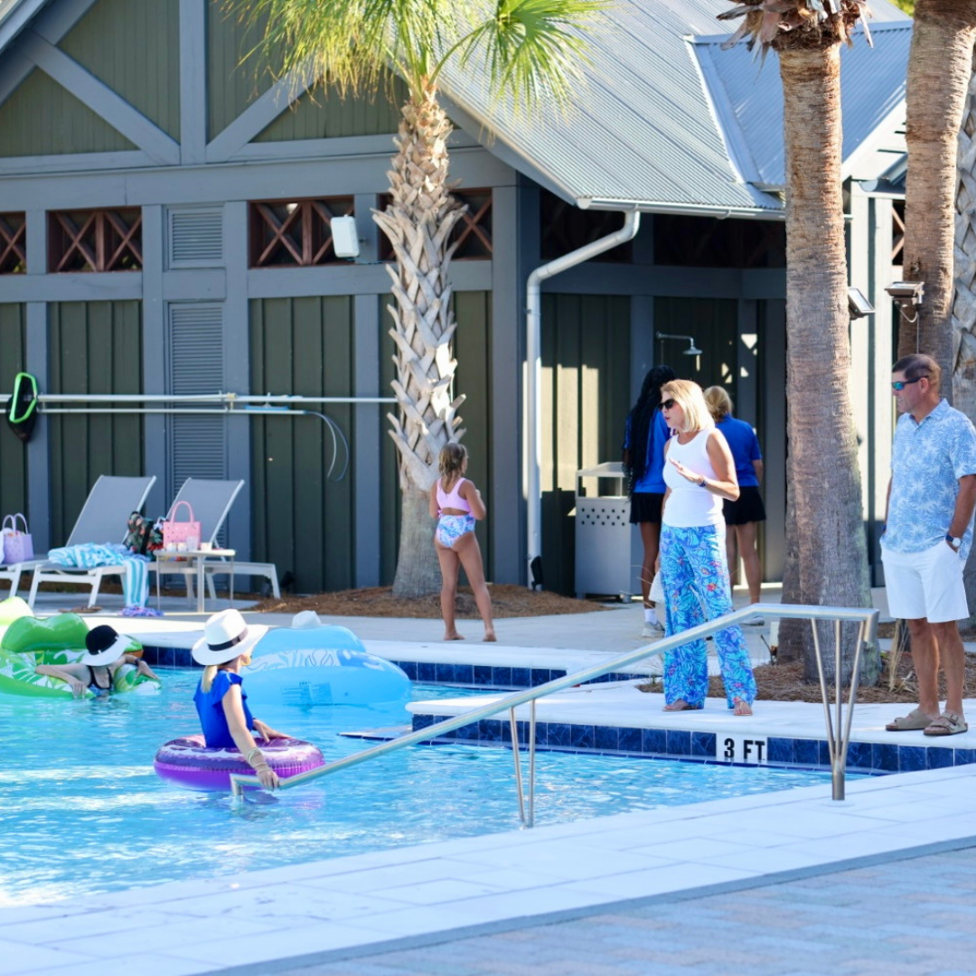 Adults gathered in and around a pool